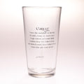 A clear glass pint glass with black printed text on a white background. The text features a poem titled 'Cancer' with a quote about moonlight on the tide and a shell.