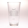 A clear glass drinking tumbler with black printed text reading 'Leo' and a playful astrological quote below, shown on a clean white background.