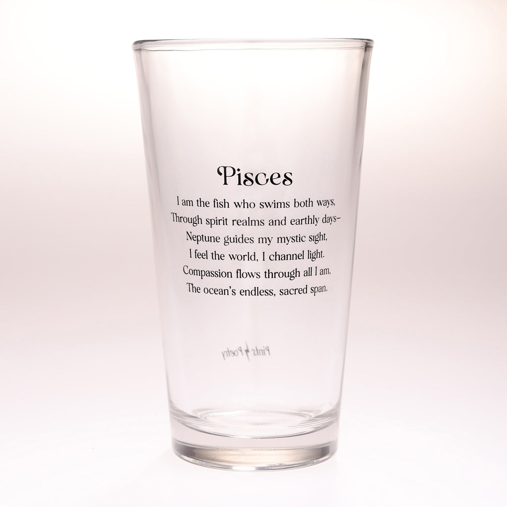 A clear glass pint glass with black printed text on the front reading 'Pisces' followed by a definition-style poem, shown on a plain light background.