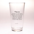 A clear glass pint glass with black printed text on the front reading 'Pisces' followed by a definition-style poem, shown on a plain light background.