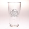 A clear glass pint glass with black printed text on the front reading 'Sagittarius' followed by a descriptive quote, photographed against a clean white background.