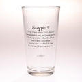 A clear glass pint glass with black printed text featuring the Scorpio zodiac sign and its astrological description, set against a plain white background.