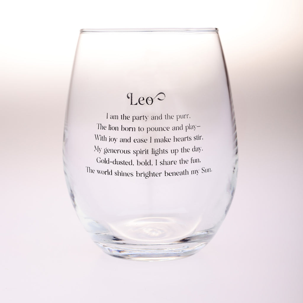 A clear stemless wine glass with black printed text reading 'Leo' and a poem about the lion, shown on a plain light background.