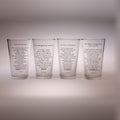 Four clear drinking glasses lined up side by side, each printed with a different poem in black text, set against a neutral gray background.