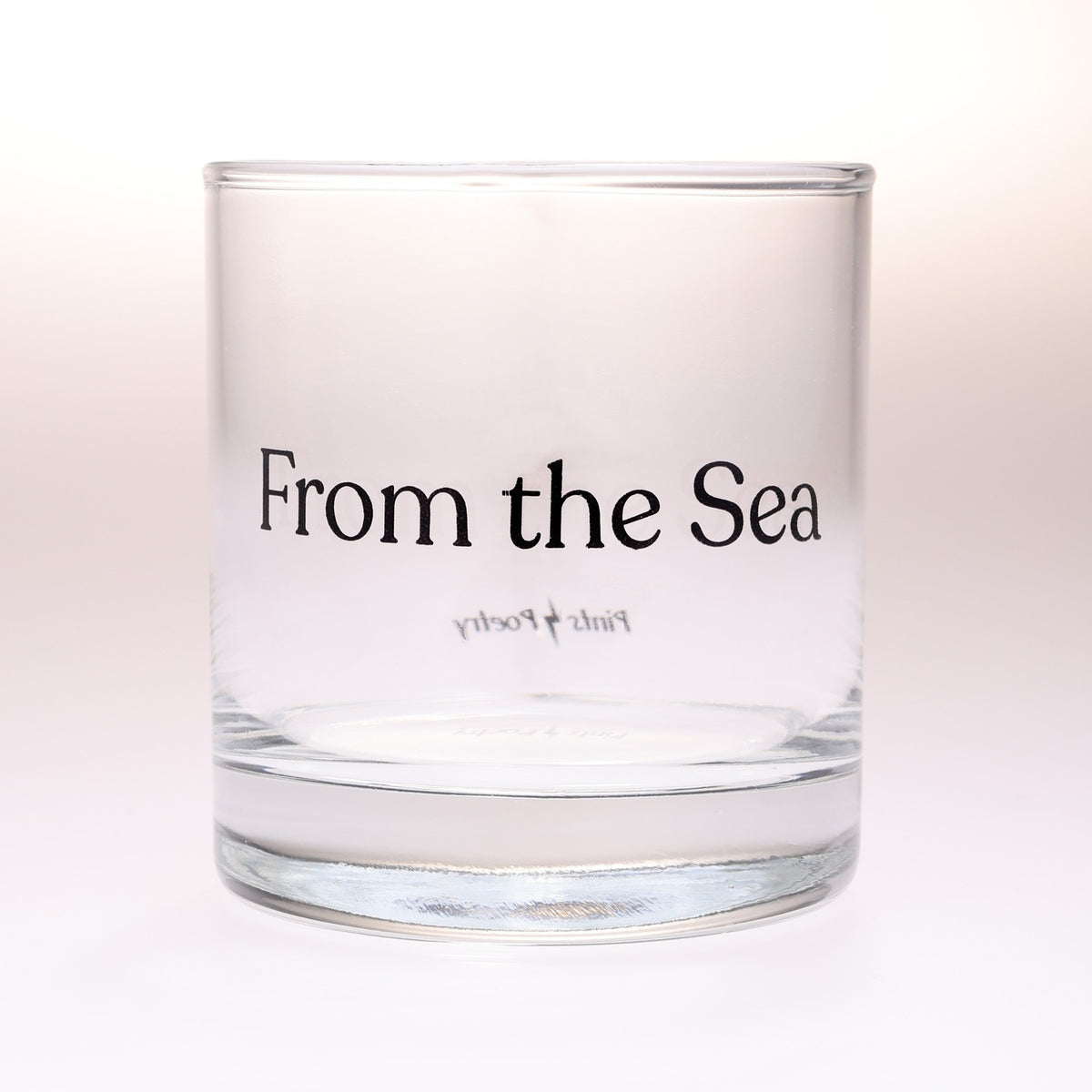 A rocks glass tumbler with the phrase 'From the Sea' printed in black serif text on the front, photographed against a clean white background.