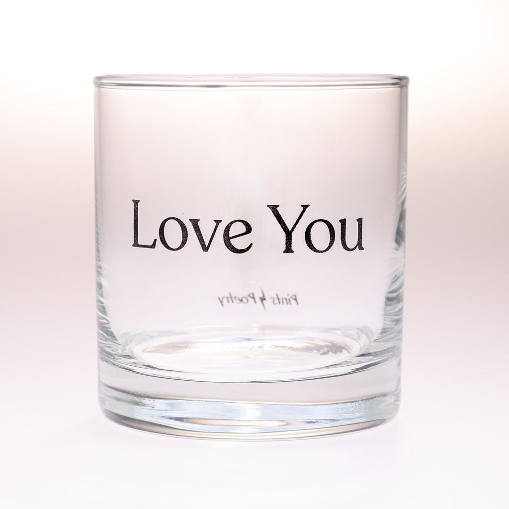 A rocks glass tumbler with the words 'Love You' printed in black serif font on the front, photographed against a clean white background.