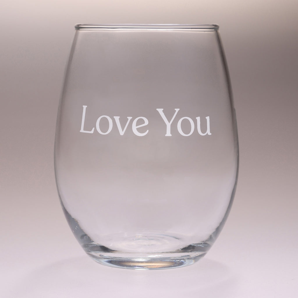 A clear stemless wine glass with the words 'Love You' printed in white serif lettering on the front, set against a neutral light gray background.
