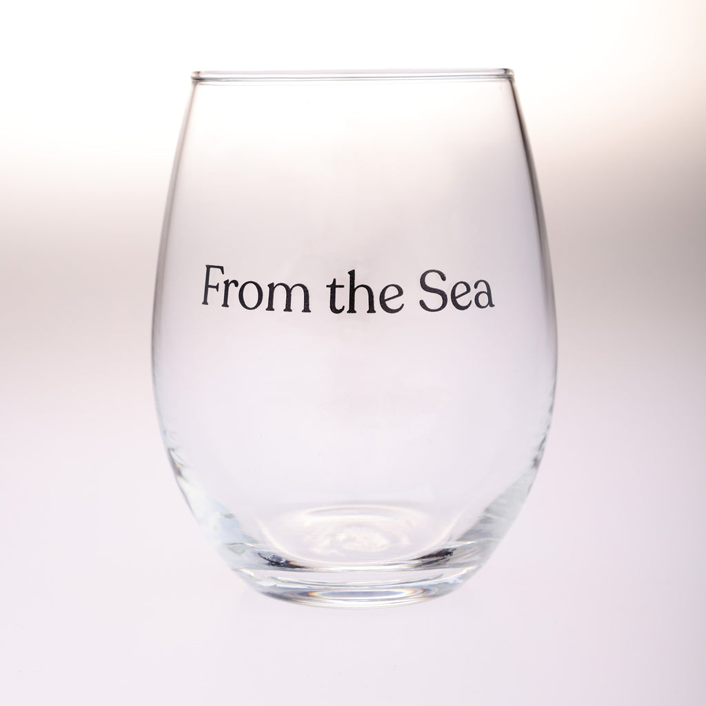 A clear stemless wine glass with the text 'From the Sea' printed in black serif font on the front, set against a clean white background.